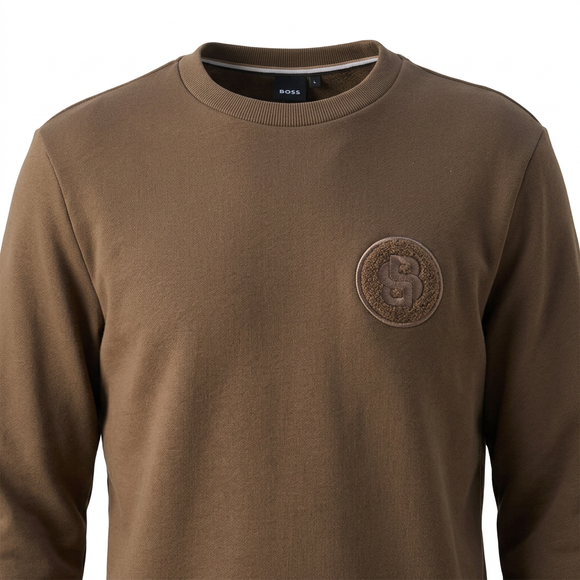 Brown sweatshirt embroidered crest close-up