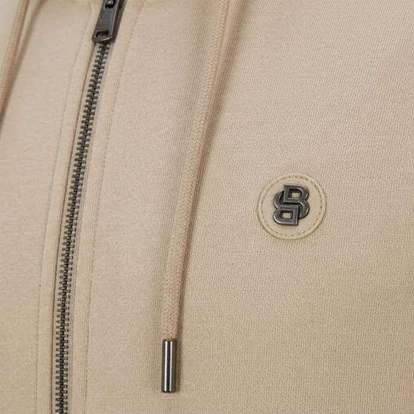 Tight close-up of BOSS hoodie metallic emblem and zipper